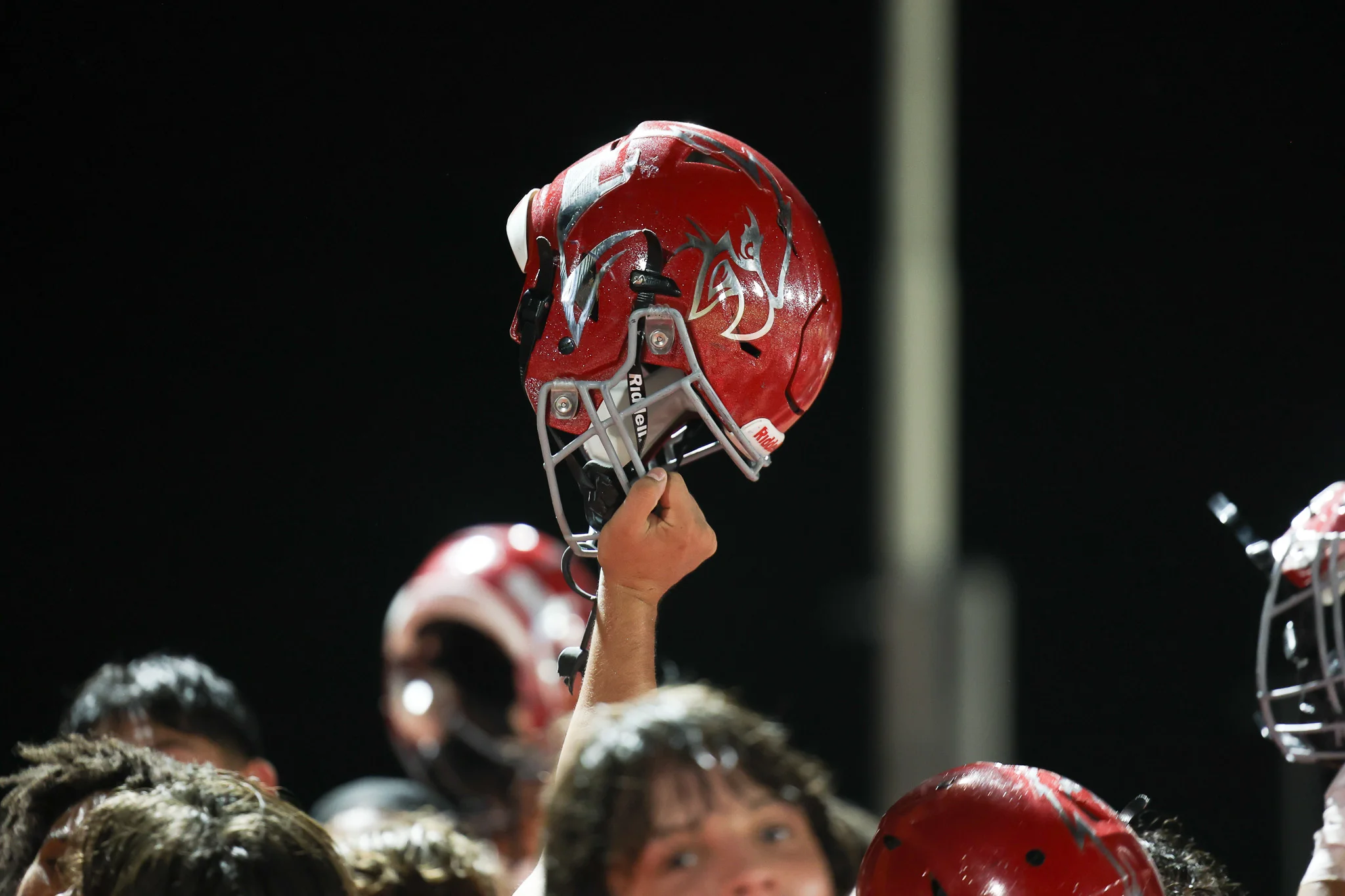 Ironwood Eagles Football Helmet held up by a Eagle